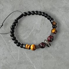 Discover the elegance of nature with our handcrafted men's bracelet made from stunning Tiger's Eye, Garnet, and Black Tourmaline stones. Each piece is carefully designed to showcase the unique energies and colors of natural stones. Whether you're looking for a stylish accessory or a meaningful gift, this bracelet is a perfect choice! 🌟 ✨ Why You'll Love It: Made with high-quality natural stones Zircon accents for extra sparkle Matches any fashion style--whether casual or formal Perfect for addi Unique Mens Bracelet, Stone Energy, Black Tourmaline Stone, Energy Protection, Protection Bracelet, Energy Stones, Men's Bracelet, Tiger's Eye, Black Tourmaline