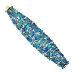 A stunning bracelet cuff is handmade in 18K gold and sterling silver. It is set in 7.97 carats emerald, 57.12 carats opal doublet, 7.42 carats tanzanite and 7.27 carats diamonds. Pair this with your favorite evening dress for a red carpet look. Clasp Closure FOLLOW MEGHNA JEWELS storefront to view the latest collection & exclusive pieces. Meghna Jewels is proudly rated as a Top Seller on 1stDibs with 5 star customer reviews. All items manufactured by us are handmade and can be customized or rede Diamond Cuff Bracelet, Gems Bracelet, Tanzanite Diamond, Sparkly Jewelry, Bracelet Cuff, Gold Jewellery Design, Cuff Bangles, Gemstone Bracelets, Opal Jewelry