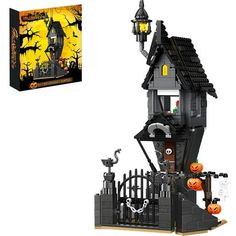 a lego halloween house with pumpkins on the front and an orange box behind it