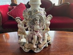 an ornate vase sitting on top of a wooden table