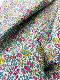 a close up view of a flowered shirt and tie