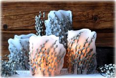 three lit candles sitting next to each other on a table