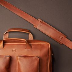 Messenger bag in tan leather by Capra Leather • Unique product design • Shoulder bag with a tan leather color • Bag detail • Functional and stylish design. Men's accessories, men's daily fashion, men's bags • Travel photo • #productdesign #bag #messengerbag #craftsmanship #leatherwork #mensaccessories #mensfashion #mensclassystyle #shoulderbag #strap #leatherdetail #briefcase #luggagestrap Adjustable Leather Bag Strap For On-the-go, Luxury Laptop Bag With Adjustable Strap For On-the-go, Leather Briefcase With Adjustable Handle, Modern Satchel With Adjustable Handle For Travel, Modern Travel Satchel With Adjustable Handle, Rectangular Leather Bag Strap For Travel, Classic Leather Bag Strap For Travel, Modern Rectangular Bag Strap For Travel, Functional Leather Briefcase With Adjustable Strap