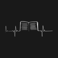 an open book with a heart beat drawn on the side in white ink against a black background