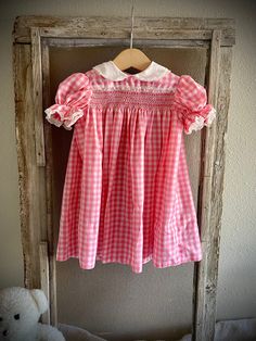 "Darling \"pre-loved\" vintage white and pink baby girl dress. There is so much detail on this dress- you can just keep looking at it forever! The combination of the plaid, the collar and the lace makes this dress so sweet!  Size of the dress is roughly 24 months. There is no tag on it so this is a rough estimate! The length from the top to the bottom is 18 inches long.  If you have any questions, please reach out! All sales are final. Thanks for stopping by! Reach out with any questions! 🤍" Fitted Pink Baptism Dress With Ruffles, Cute Pink Baptism Dress With Ruffles, Sweet Short Sleeve Dress For Baptism, Pink Cottagecore Vintage Dress With Ruffles, Cottagecore Pink Vintage Dress With Ruffles, Sweet Pink Dress For Baptism, Sweet Pink Baptism Dress, Fitted Pink Baptism Dress With Short Sleeves, Fitted Short Sleeve Pink Baptism Dress