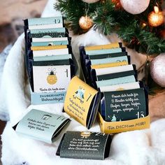 several different types of christmas cards in front of a christmas tree with ornaments on it