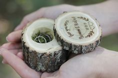 two pieces of wood with wedding rings in them