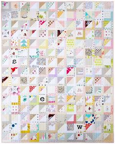 a quilt made with many different colors and shapes