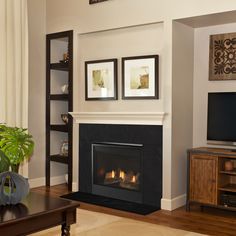 a living room filled with furniture and a fire place in front of a flat screen tv