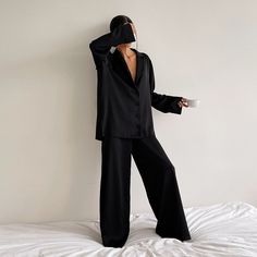 Silk Pajamas that you won't change out of and luckily, don't have to. Wear this soft and silky matching set all day long, or wear it out. Our Olivia Silk Pajamas is another sleepwear favorite this season and features a matching long sleeve top and wide-leg pant bottoms. The pants feature an elasticated waist, silky touch, and high waist. The long-sleeved top features a v-neckline, a loose fit, a single-breasted button closure, and a turn-down collar. The best matching set for lounging around the Pijamas Women, Wide Leg Pant Suit, Pyjama Satin, Pajama Fashion, Silk Sleepwear, Silk Pajama Set, Long Sleeve Tops Casual, Satin Pyjama Set, Satin Shirt