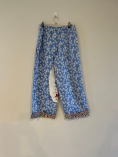 These georgeous size 10 retro trousers were on of my favourite things to make.  The trousers are a very relaxed style with wide legs for comfort.  The pants are created from a preloved retro sheet and a vintage soily I have loved and collected over time.    The trousers feature an elasticised waist band for comfort and fit.   They feature generous inseam pockets and I was able to feature the vintage doily I loved - to cover a little fault in the preloved fabric.   The trouser legs are finished with a retro fabric for the cuffs  The pants are a relaxed style to comfortably fit  on Hips:  85-89cm, Waist:  63-67cm,  The trousers are priced at $69.00 with free delivery in Australia. Straight Pants With Pockets For Pajama Party, Retro Wide-leg Pants With Relaxed Fit, Retro Relaxed Fit Wide Leg Bottoms, Retro Wide Leg Bottoms With Relaxed Fit, Vintage Style Relaxed Fit Wide-leg Pants, Retro Straight Pants Relaxed Fit, Retro Relaxed Fit Straight Pants, Relaxed Fit Retro Straight Pants, Straight Leg Cotton Bottoms For Pajama Party