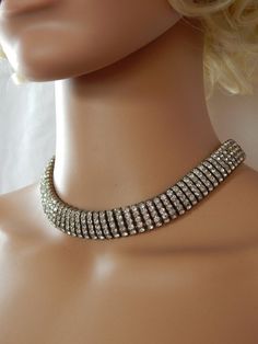 Vintage Rhinestone Collar Necklace, Art Deco Hollywood Regency Wide Rhinestone Choker Necklace, Bridal Wedding Jewelry, Estate Jewelry♥ Gorgeous mid century wide collar necklace featuring rows of brilliantly clear rhinestones.  Stunning show-stopping statement necklace that will attract tons of compliments! Simply stunning, a perfect fit for a Hollywood diva or a glamorous bride!♥ Secure push-in box closure with a safety catch♥ Necklace measures approx. 15" long and 3/4" wide♥ Excellent conditio Vintage Silver Choker For Evening, Silver Rhinestone Wedding Choker, Wedding Choker With 17 Jewels, Vintage Rhinestone Choker For Party, Antique Rhinestone Necklaces For Formal Occasions, Wedding Rhinestone Choker Necklace, Bling Rhinestone Choker For Wedding, Wedding Rhinestone Choker Necklace With Bling, Glamorous Wedding Necklace With Stones