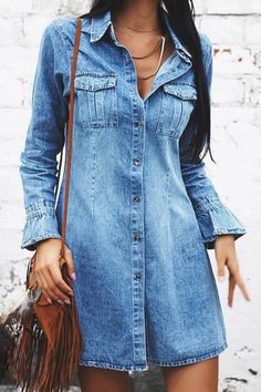 a woman wearing a denim dress and hat