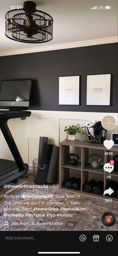 a room that has a treadmill and some pictures on the wall above it,