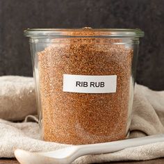 a jar filled with brown sugar next to a spoon