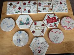 christmas coasters are arranged on a wooden table