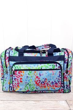 "23\" NGIL Rainbow Cheetah Duffle Bag Great for a weekend travel bag. Duffel Bag Description: Great for short trips! Soft Canvas Construction Zip Around Top Closure 2 Outside Zip Pockets Plastic Feet on Bottom Double Handles with 10\" Drop Detachable Adjustable Shoulder Strap 23\" Wide x 12.5\" Tall x 10.5\" Deep ORDERING INFORMATION Please put the following information in the \"Notes to Seller\" at checkout: 1. Name for Personalization 2. Please let me know what color of thread you would like. Black Duffel Bag, Cheer Bag, Women Lunch Bag, Weekend Travel, Lunch Tote, Duffel Bags, Travel Duffel, Duffel Bag Travel, Monogram Styles