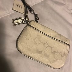 Nwt White Coach Wristlet. Never Used. White Rectangular Clutch With Zipper Closure, Elegant White Clutch With Zipper Closure, White Pouch Wristlet With Zipper Closure, White Clutch Wristlet With Zipper Closure, White Clutch With Wrist Strap For Everyday Use, Chic White Wristlet With Zipper Closure, Chic Cream Coach Wristlet, White Clutch With Zipper Closure For Gift, White Clutch Wristlet With Wrist Strap