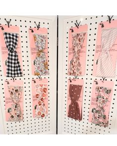 several different types of ties are hanging on the wall in front of polka dot paper