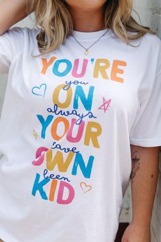 You're On Your Own Kid Tee Playful Letter Print T-shirt, School Spirit Graphic Print Tops For Spring, Spring Graphic Print Top For School Spirit, Unisex White Printed Tops, Unisex Printed White Tops, Fun White Tops With Funny Print, Fun Tops With White Funny Print, Playful Cotton Printed Tops, Playful Printed Cotton Tops