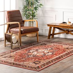 a living room with a rug, chair and coffee table on the floor in front of a potted plant