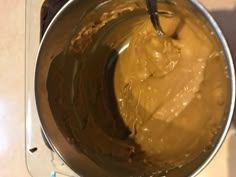 a metal bowl filled with batter on top of a counter