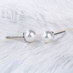 Sublime in their simplicity, these pearl stud earrings are truely timeless. Expertly crafted, each classically styled earring features a 7 mm cultured pearl set atop a sterling silver post setting. This is the perfect gift for your loved one or a great accessory to add to your own collection.Weight: 1.9 gWidth: 7.4 mmHeight: 7.85 mmThickness: 7.4 mmMaterial: Plating Color: Silver Classic Sterling Silver Pearl White Earrings, Classic Hypoallergenic Pearl White Pearl Earrings, Classic White Pearl Earrings For Pierced Ears, Classic Silver Pearl Earrings, Sterling Silver Stud Earrings, Pearl Set, Silver Stud Earrings, Pearl Stud Earrings, Online Earrings