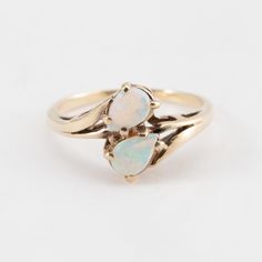 Hi. This is a pretty double opal ring, set in 10k yellow gold. It is marked 10, but faded, on the inside of the band. The opals are tear drop shaped. The ring finger size is 5.5. Sorry, we do not resize rings. The weight of the ring with the stones is 2 grams. Thanks for looking. 14k Gold Teardrop Ring, Fine Jewelry 14k Gold Pear-shaped Opal Ring, Teardrop Opal Promise Ring In Fine Jewelry Style, Teardrop Opal Promise Ring Fine Jewelry, 14k Gold Pear-shaped Opal Ring Fine Jewelry, 14k Gold Pear-shaped Opal Ring, Pear-shaped 14k Gold Opal Ring Fine Jewelry, Pear-shaped 14k Gold Opal Ring, Fine Jewelry Teardrop Opal Ring For Anniversary