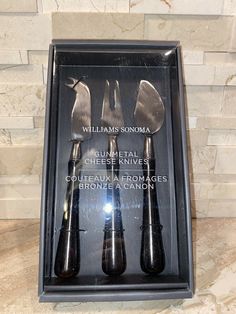 three knives in a black box on a marble counter top with the words williams sonoma written below it