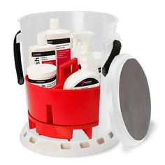 a red and white bucket filled with cleaning supplies