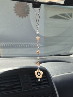 a car dashboard with a chain hanging from it's center console