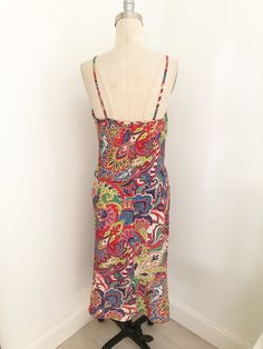 This is a midi dress by Eye Candy. The bright colored stylized paisley print makes this dress so much fun. Spaghetti straps, unlined. Perfect little number for any summer occasion. Made in USA, 100 percent polyester, Size tag L. Check measurements carefully, no stretch. Measurements taken with dress laying flat and doubled where appropriate. In order to determine fit we recommend comparing measurements with an item that fits you well. Length 46 inches Underarm to underarm 34 inches Waist 36 inch Colorful Floral Print Midi Dress, Colorful Floral Print Midi Dress For Beach, Colorful Floral Print Midi Dress For Summer, Colorful Spaghetti Strap Beach Dress, Colorful Vibrant Print Midi Dress For Summer, Multicolor Printed Midi Sundress, Colorful Sleeveless Midi Dress For Vacation, Colorful Pattern Sleeveless Midi Dress For Vacation, Printed Midi Dress With Spaghetti Straps For Summer