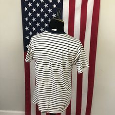 "Description: -In Semi-Distressed Shape Overall -Embroidered Design -Blue Striped Pattern Defects: Some Pilling along Collar. Several Holes on the Chest Graphic Area. Hole on Bottom Front of Tee. Staining across Shirt: --Bottom Front of Tee, --Armpit Areas, --Back Bottom, --and Back Side of Shirt. ID: 5D535 Measurements: L Chest (Across the Chest): 21\" Arm (Shoulder to Cuff): 8\" Overall (Front) Length: 25\"" Classic Striped Crew Neck Shirt, Casual American Flag Print T-shirt With Relaxed Fit, Casual Relaxed Fit T-shirt With American Flag Print, Casual American Flag Print T-shirt, Relaxed Fit, Casual American Flag Print Relaxed Fit T-shirt, Classic Striped Cotton T-shirt, Blue Short Sleeve T-shirt With American Flag Print, Casual Short Sleeve Shirt With American Flag Print, Vintage Navy Cotton T-shirt