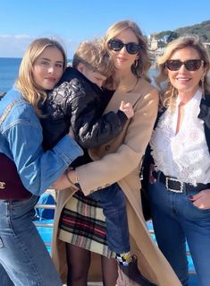 three women and a child posing for a photo