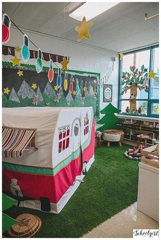 the classroom is decorated for christmas with decorations on the walls and green grass in front