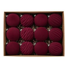 twelve red round macaroons in a cardboard box