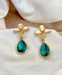 Enhance your elegance with our Green Teardrop Flower Earrings. These dainty and graceful accessories bring a touch of nature's beauty to your ensemble. Delicate gold flowers and a green crystal teardrop make them perfect for any occasion, from casual gatherings to special events. Handcrafted with care, these earrings are a delightful addition to your jewelry collection, offering a unique blend of charm and sophistication." *925 Silver posts * Crystals Gold flower earrings, green bridesmaid earrings, teardrop earrings, boho bridal earrings, whimsical earrings, woodland wedding, wedding gift Boho Bridal Earrings, Whimsical Earrings, Gold Flower Earrings, Earrings Teardrop, Green Bridesmaid, Earrings Green, Boho Bridal, Woodland Wedding, Green Crystal