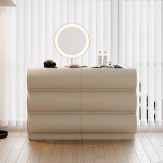 a white dresser with a mirror on top of it