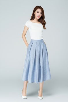 "Spring has sprung in this blue midi skirt from Xiaolizi. The linen skirt built in a high-rise, A-line silhouette with pleating throughout. The summer circle skirt topped with a banded waist + two seam pockets. DETAIL * 50% linen, 50% cotton * No lining * Seam pocket * Back zipper closure * Below Knee Length * Pleated Skirt * Perfect for summer, spring * Wash by hand or machine with cold water * The model is 163cm (5′4″) tall with a 80cm (31.5\") bust, 66cm (26\") waist. She is wearing the blue Midi Skirt Outfit Casual, Blue Linen Skirt, Midi Rock Outfit, Blue Skirt Outfits, Light Blue Skirts, Blue Midi Skirt, Work Skirt, Midi Skirt Outfit, Tailored Clothes