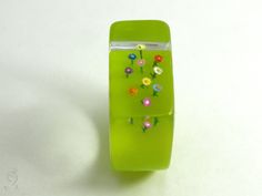 "NOW IT IS GETTING COLORFUL! A lovely, handmade unique for everyone who like it colorful. On a flashy green ring grow ten colorful mini-flowers up to the sky. The ring is very light and despite of the size extremely good to wear. Moreover it is a hand charmer and always an eye-catcher. SIZE/DIMENSIONS/WEIGHT This ring will be produced suitable for you (I need about three weeks for the production). Please specify your ring size (you can measure the inner diameter of a matching, wider ring). about Flower Shaped Enamel Ring For Gift, Multicolor Flower-shaped Rings For Spring, Flower-shaped Enamel Ring For Gift, Colorful Flower Garden, Multicolor Flower-shaped Jewelry With Floral Print, Multicolor Floral Print Flower-shaped Jewelry, Mini Flowers, Up To The Sky, Green Ring