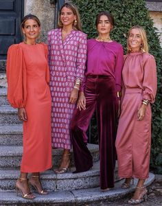 three women standing next to each other on steps