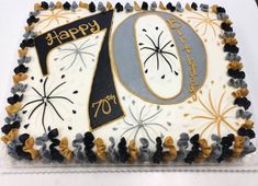 a white and black birthday cake with the number 70 on it's icing