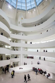 people are standing in the middle of a large room with many circular walls and ceilings