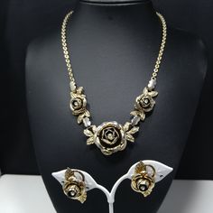 *Description: This is a vintage 3D rose necklace & screw back earring set with clear rhinestone centers from the late 1940s to 1950s. The necklace has three roses with the largest in the center. The matching screw back earrings have the same 3D design with a single rose center and two leaves on each with the clear rhinestone center. I tested the surface since they look silver tone with a gold wash. The gold wash tested at 10K gold and the metal under the gold wash is magnetic and silver in t Vintage Rose Gold Jewelry For Evening, Rose Gold Vintage Jewelry For Evening, Vintage Rose Design Jewelry For Formal Occasions, Vintage Metal Jewelry With Rose Design, Vintage Gold Jewelry Sets For Anniversary, Vintage Jewelry Sets For Formal Occasions, Three Roses, Formal Earrings, Vintage Christmas Gifts