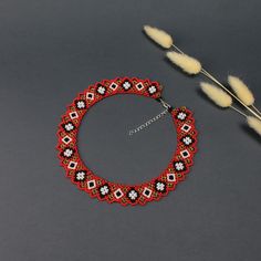 A Thoughtful and Unique Gift for Women🎁 Celebrate her achievements with this stunning seed bead collar necklace, the perfect graduation gift for her. This handmade bead necklace is a beautiful and unique gift that will make any woman feel special and appreciated. Striking Red, Black, White, and Gold Colors❤️ This exquisite necklace features a vibrant color palette of red, black, white, and gold. The bold and sophisticated combination of colors creates a striking statement piece that enhances an Gift Red And Black Beaded Necklaces, Red And Black Beaded Necklaces For Gifts, Gift Red Beaded Necklaces With Black Beads, Red Beaded Necklaces With Black Beads For Gifts, Red And Black Beaded Necklace For Gift, Red Bib Necklace As Gift, Handmade Red Beaded Choker Necklace, Red Necklace With Black Beads For Gift, Red Necklace With Black Beads As Gift