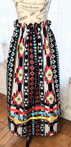 A Tribal Black Native American Ribbon Skirt made with duck cloth fabric made with 4 different colored ribbons: black, red, teal, and yellow. The length of the skirt is 36 inches but can be adjusted to your own personal  length and waist size can also be adjusted to your personal waist measurement, a 1 1/4 inch elastic is used for the waist. The skirt is made with pockets made with black poly satin fabric. Ribbon Skirts are traditionally made in a full length so just keep in mind as long as the w Black Bohemian Maxi Skirt For Festival, Bohemian Black Maxi Skirt For Festival, Black Lined Skirt For Festival, Festival Black Lined Skirt, Black Bohemian Midi Skirt, Traditional Black Skirt For Summer, Traditional Black Flowy Skirt, Traditional Black Lined Skirt, Ribbon Skirts Native American