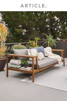 an outdoor patio with furniture and potted plants