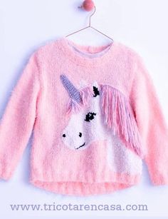 a pink sweater with a unicorn on it