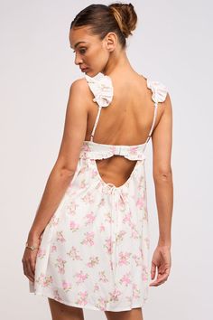 Throw on the Lulu White and Pink Floral Ruffle Mini Dress for your next country concert or trip to Nashville! White, pink and green floral fabric shapes this bustier babydoll dress with ruffle straps and a cutout back. Features ruffle trim at the bust. Style with cowboy boots for a cute and fun look! DETAILS & FIT Hits at Upper Thigh. Flowy Silhouette. Rayon. Lining: Polyester. Machine Wash Cold. Imported. Country Concert Dress, White Summer Dresses, Green Floral Fabric, Rush Outfits, Homecoming Ideas, Floral Bustier, 27 Dresses, Country Dresses, Country Concert