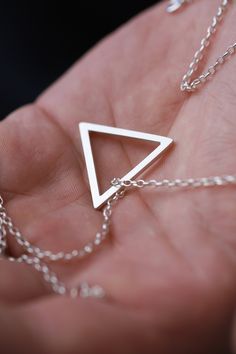 This hollow triangle mens necklace is made of 925 solid sterling silver and has a brushed matte finish. Pendant rests on a long 60 cm sterling silver chain. Simple geometric design makes it perfect and lightweight necklace for everyday wear. Measurements: Pendant width: 2.4 cm / 0.8 inch Chain length: 60 cm / 23 inch For the length changes please send me a message, and I'll be happy to adjust it for you. Want to see more jewelry from my shop? click here: http://etsy.me/2uPuv0x Want to see more m Minimalist Silver Triangle Necklace, Silver Triangle Necklace For Gift, Minimalist Silver Pyramid Jewelry, Minimalist Sterling Silver Triangle Necklace, Pendant Necklace Men, Rustic Necklace, Necklace Men, Triangle Necklace, Classic Earrings